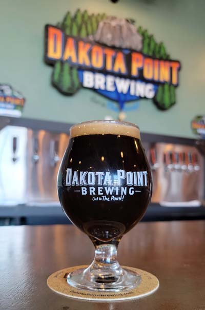 dakota point's antoinette's antidote french-toast inspired pastry stout in a stemmed and logo'ed tulip glass