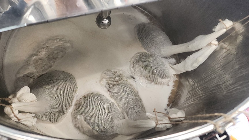 Bagged hops in kettle.