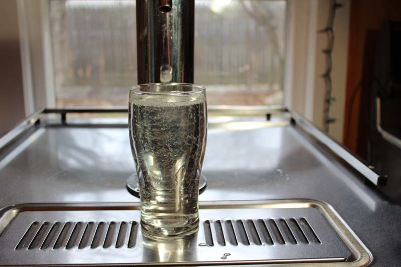 hard seltzer or hops water poured from a tap