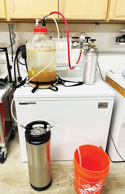 A closed-system transfer from fermonster fermenter into a Corny keg.