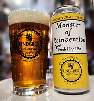 Glass of beer next to Monster of Reinvention can.