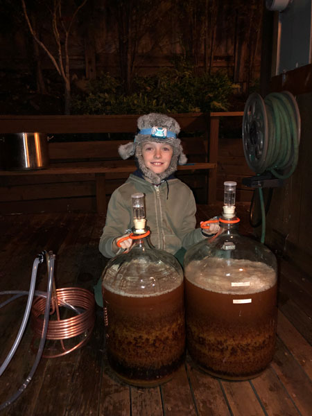 young Owen Shore and his filled carboys of Resilience IPA